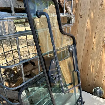 Excavator cab glass panels