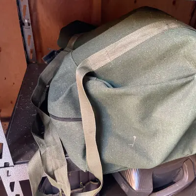 Auger in canvas duffel bag