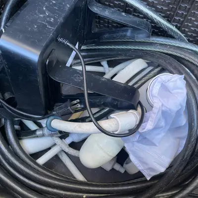 Old pool cleaner, hose, and broken Beatbot charger