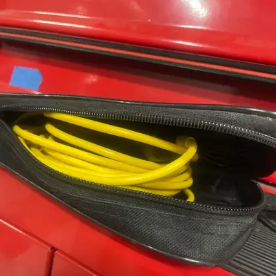 Zippered pouch with coiled yellow cable