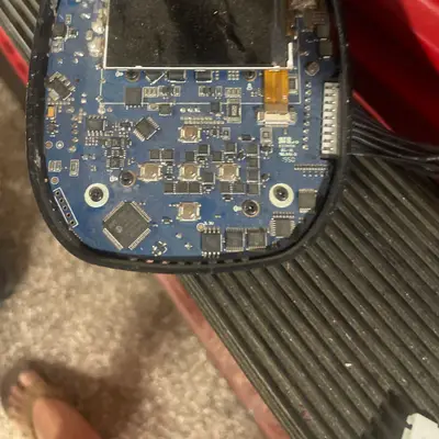 Disassembled round electronic device (LCD + circuit board)